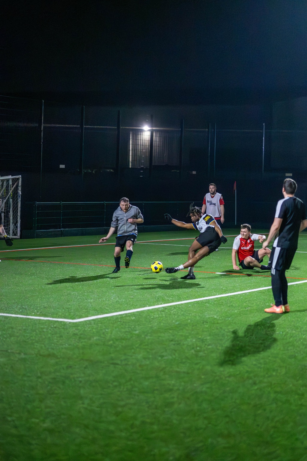 Competitive tackle during a casual football session for adults