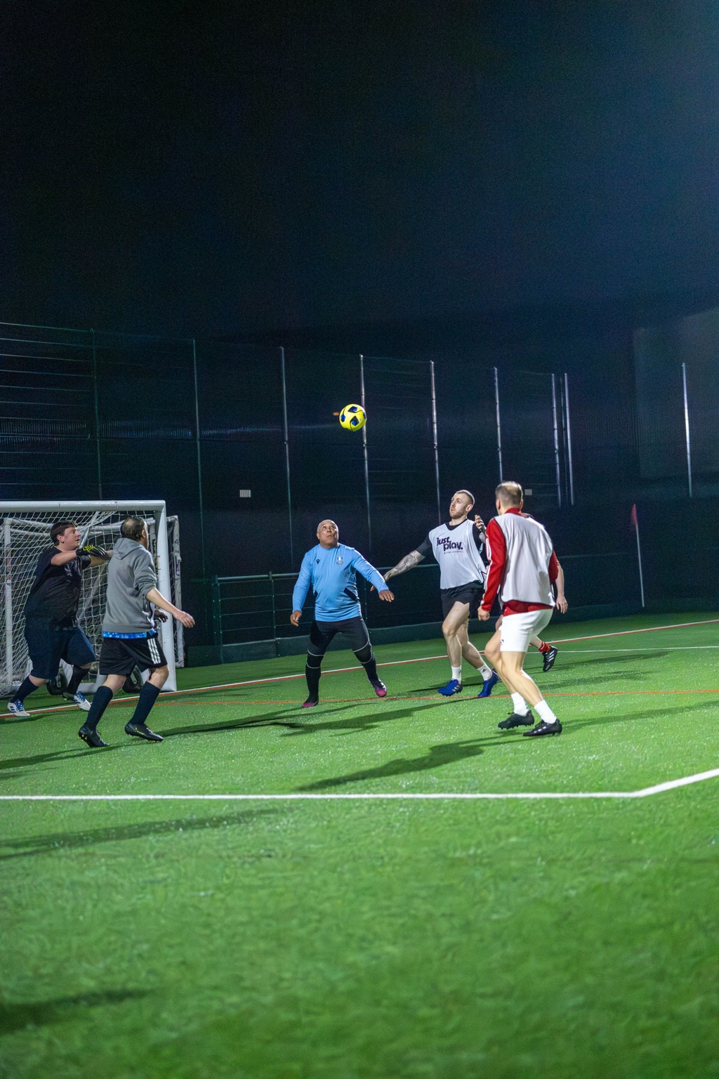 Aerial challenge between players at a pay-as-you-play football event